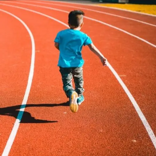 Child running on a track