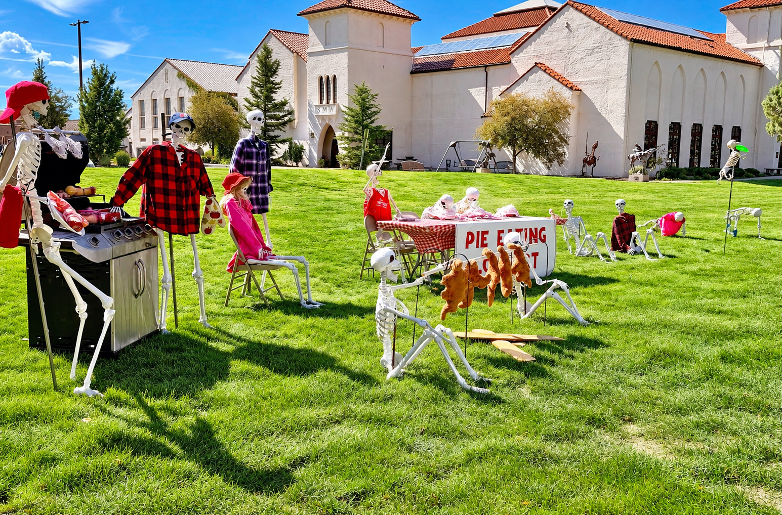 Halloween skeleton displays on the lawn at Springville Museum of Art